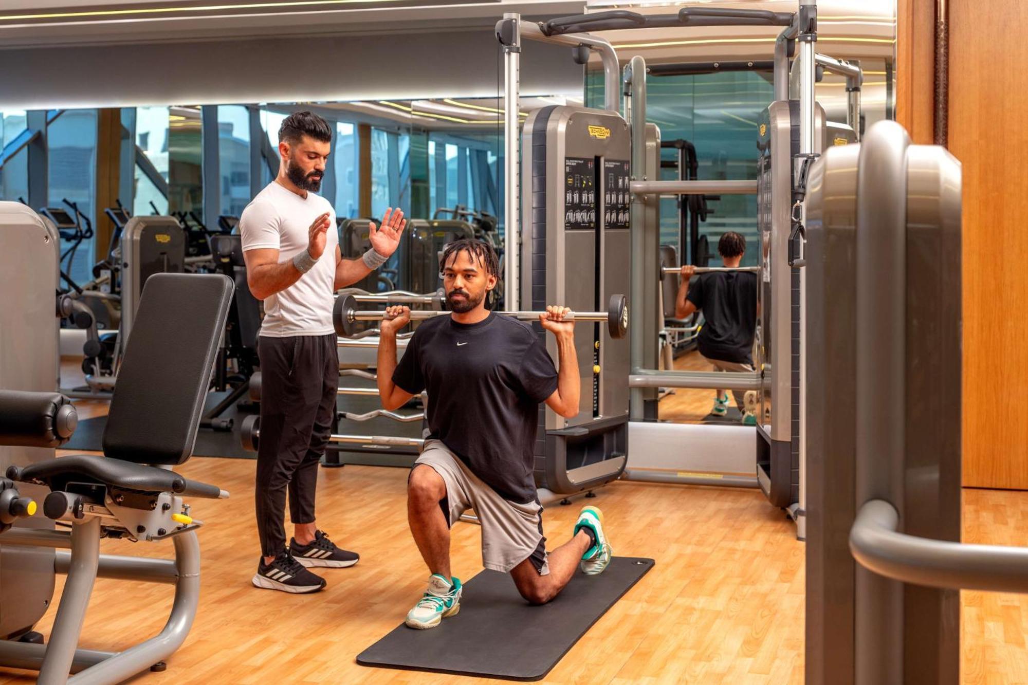 Hyatt Regency Riyadh Olaya Ngoại thất bức ảnh Personal trainer coaching a man on a Bulgarian split squat